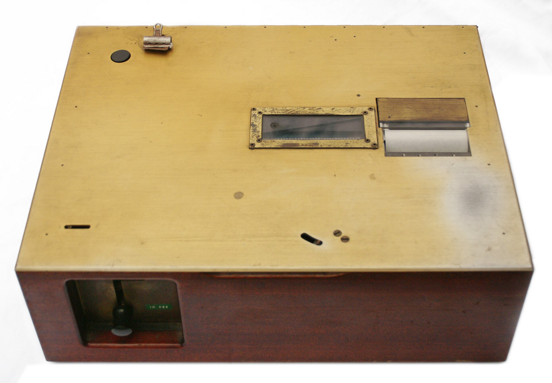 A wooden desktop machine with a window showing a question and a knob for entering an answer.